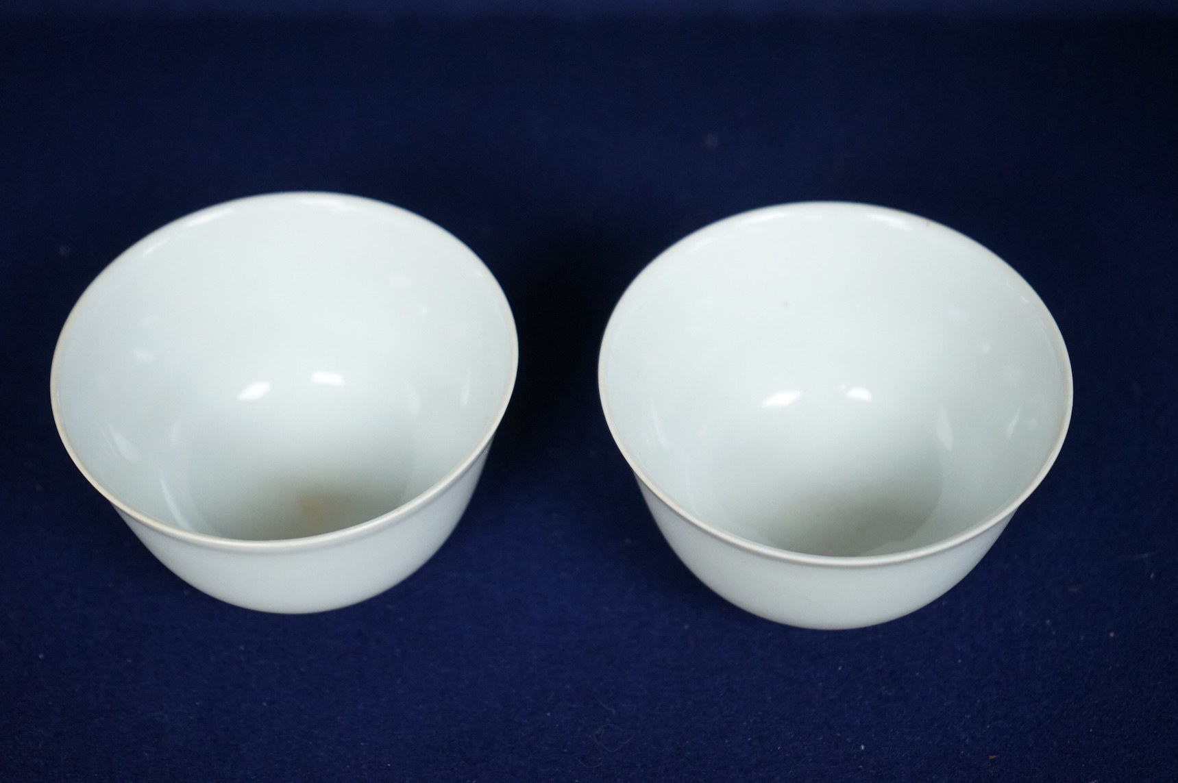A pair of Chinese white glazed porcelain tea bowls, 6cm high